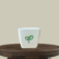 Alternate Text: A white 3 inch plastic square pot with the Pick Your Plant logo (two green stylized leaves) displayed prominently on a round, dark wooden pedestal or table against a plain, light beige background.